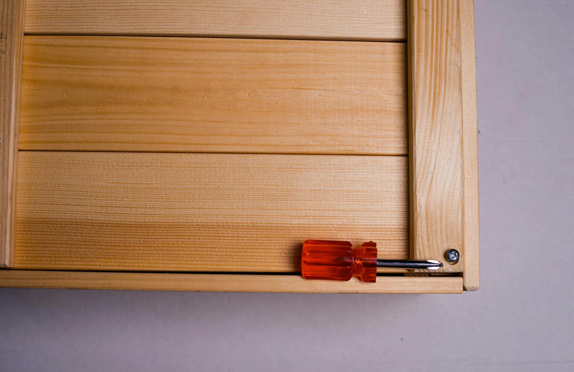 Person assembling a flat pack desk with tools
