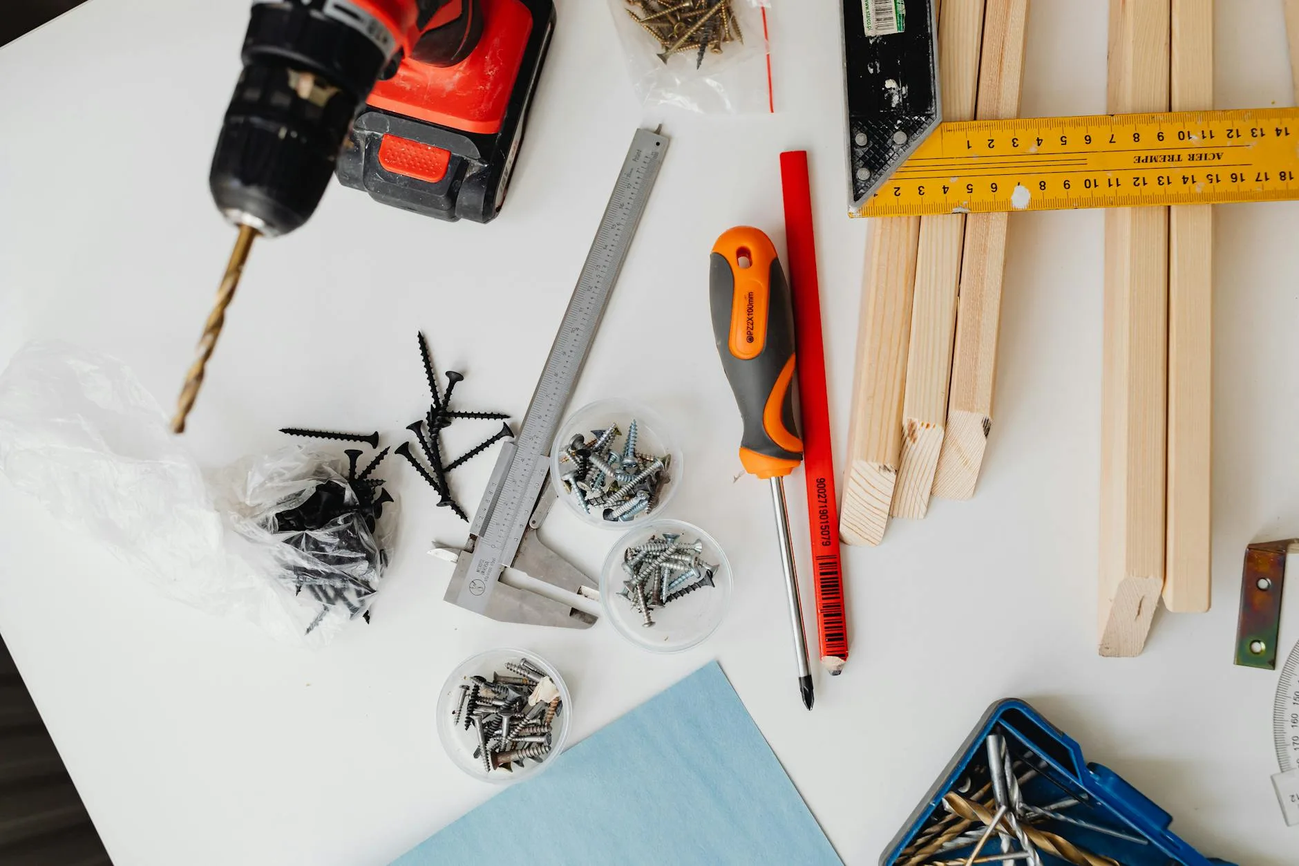 Person assembling a flat-pack standing desk with tools laid out