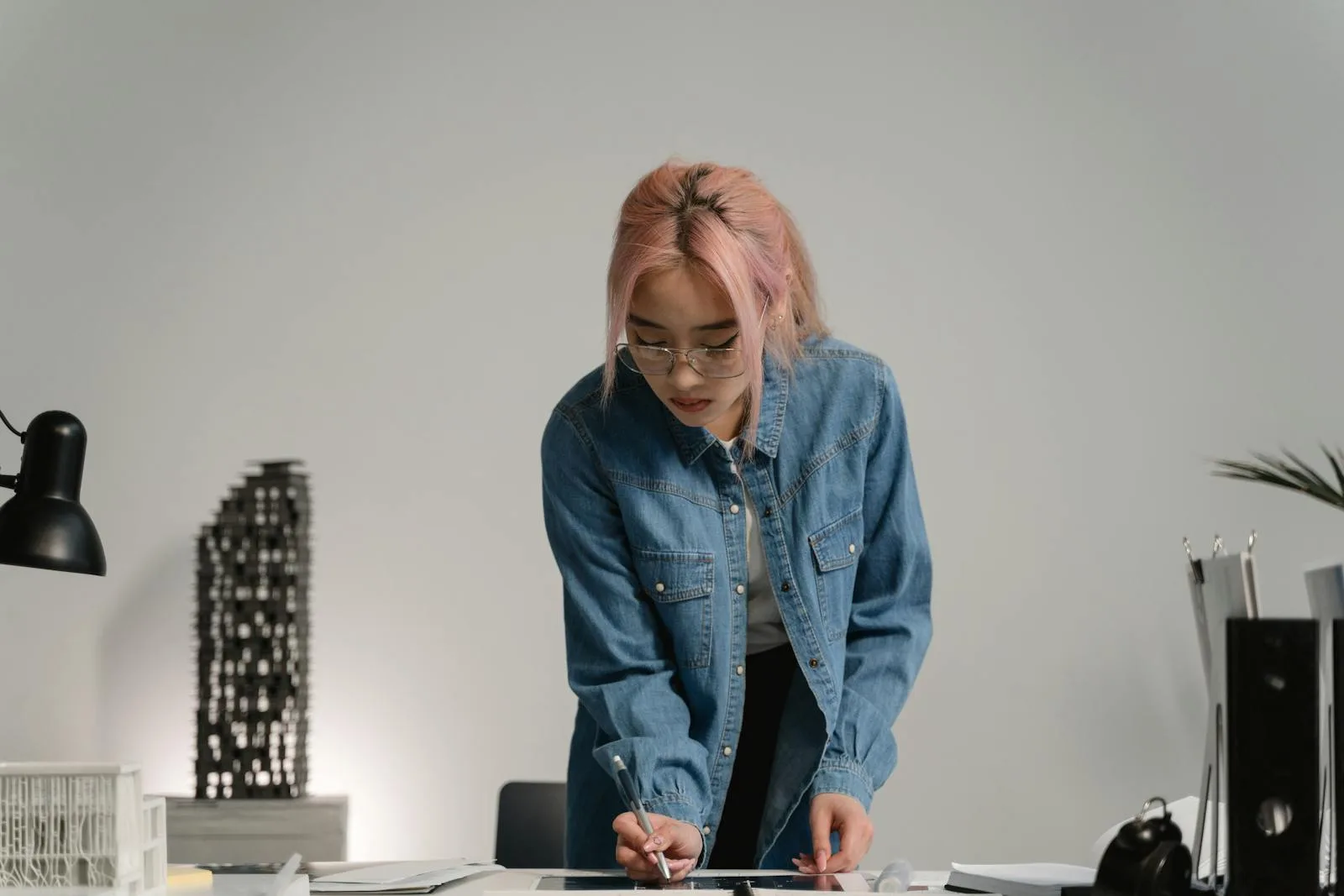Person working at a standing desk in a creative studio workspace