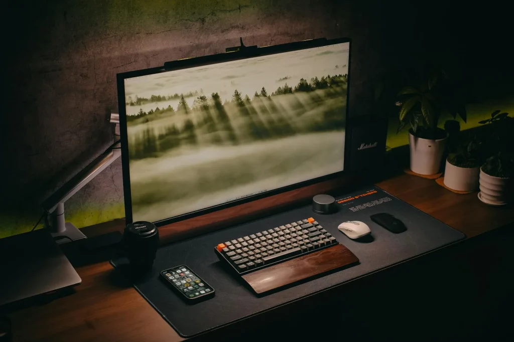 Dark minimalist desk setup with monitor and keyboard