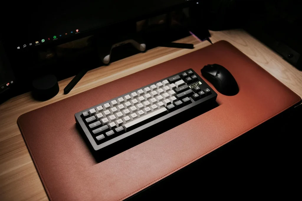 Clean desk setup with a desk mat under keyboard and mouse