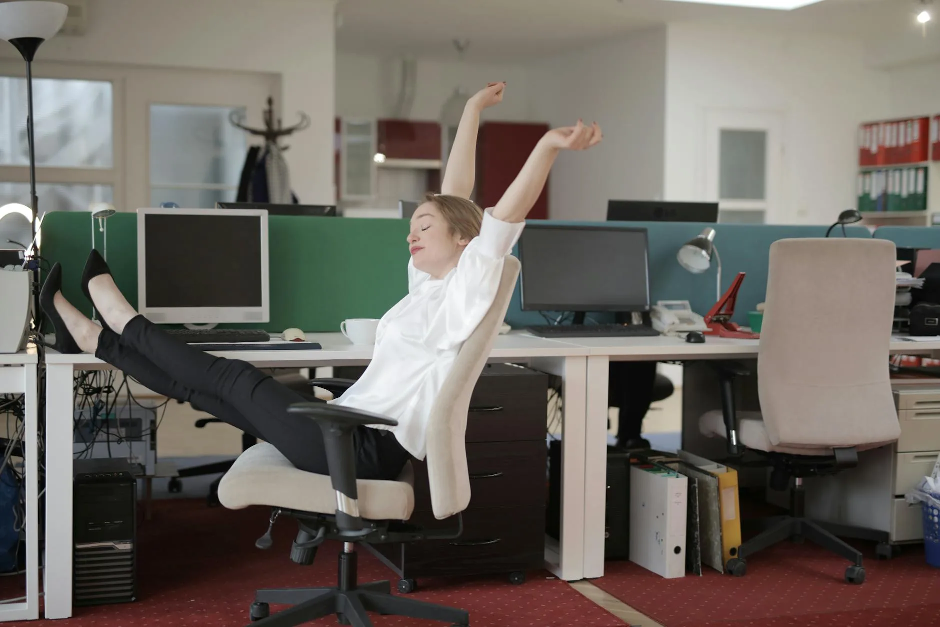 Person stretching at their desk during an office work break