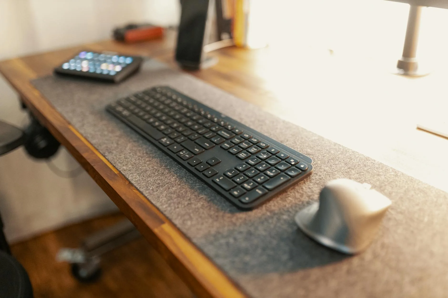 Keyboard and mouse on a desk mat workspace