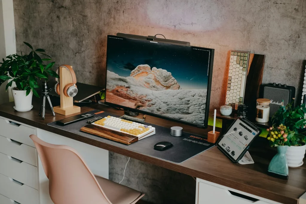 Compact home office desk setup in a small flat with laptop and monitor