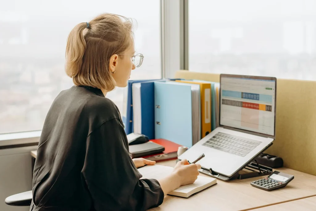 Person working at a desk with natural light from a window
