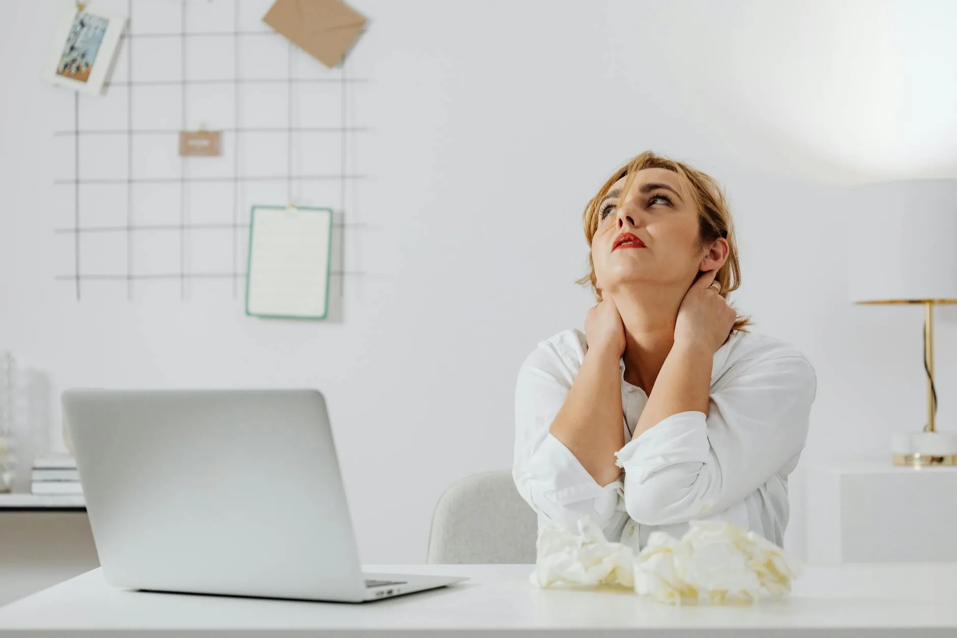 Office worker experiencing neck strain at a desk