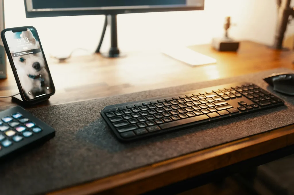 Wireless charging pad on a tidy desk next to a phone