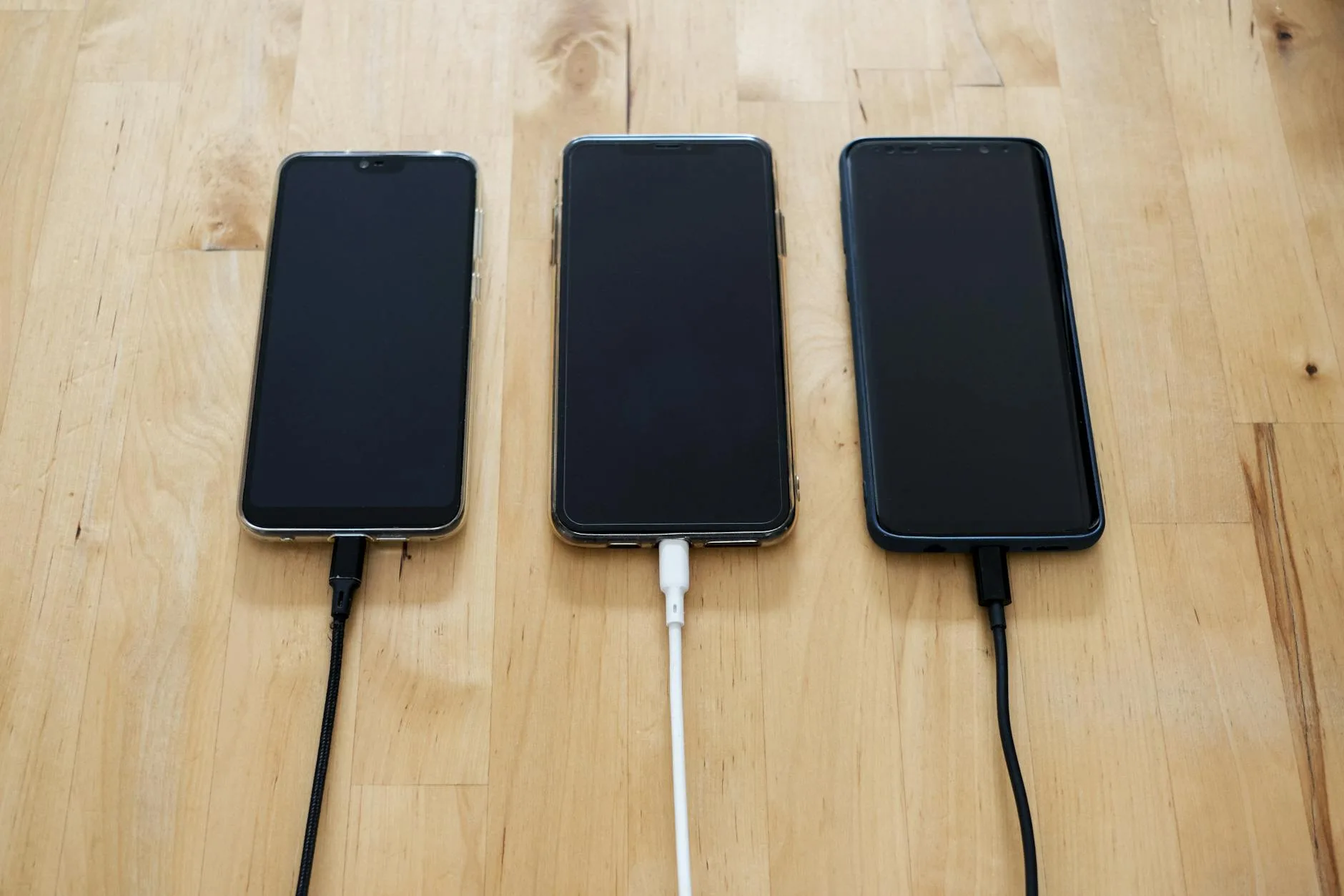 Smartphone charging on a desk with a cable connected