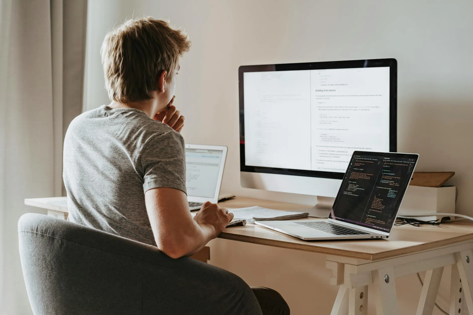 Person working at multiple monitor productivity setup