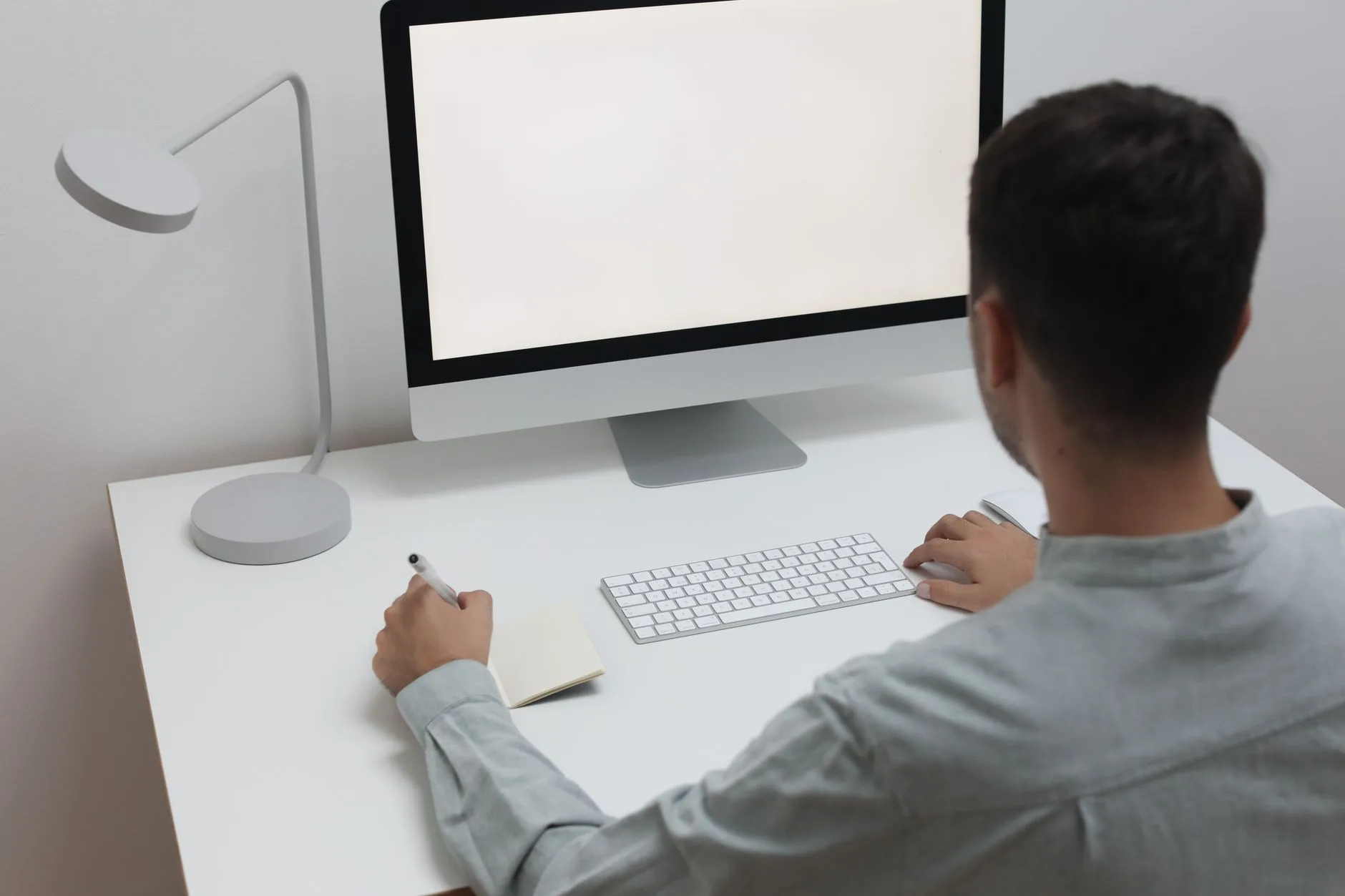 LED desk lamp lighting a notebook and keyboard