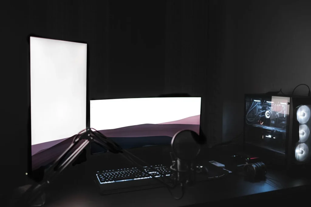Gaming desk setup with monitor microphone and streaming lights