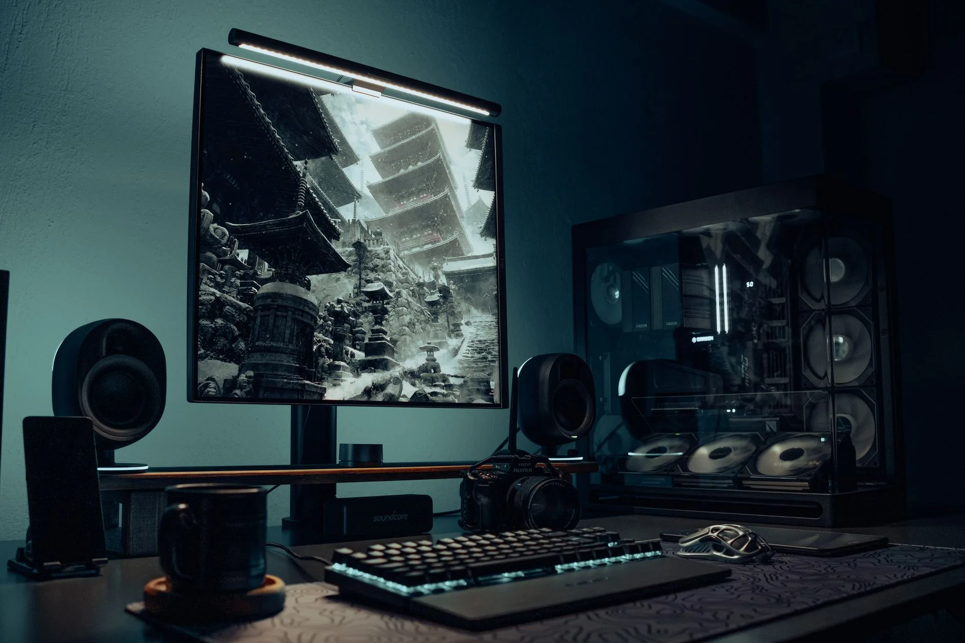 Monitor light bar illuminating a keyboard on a desk