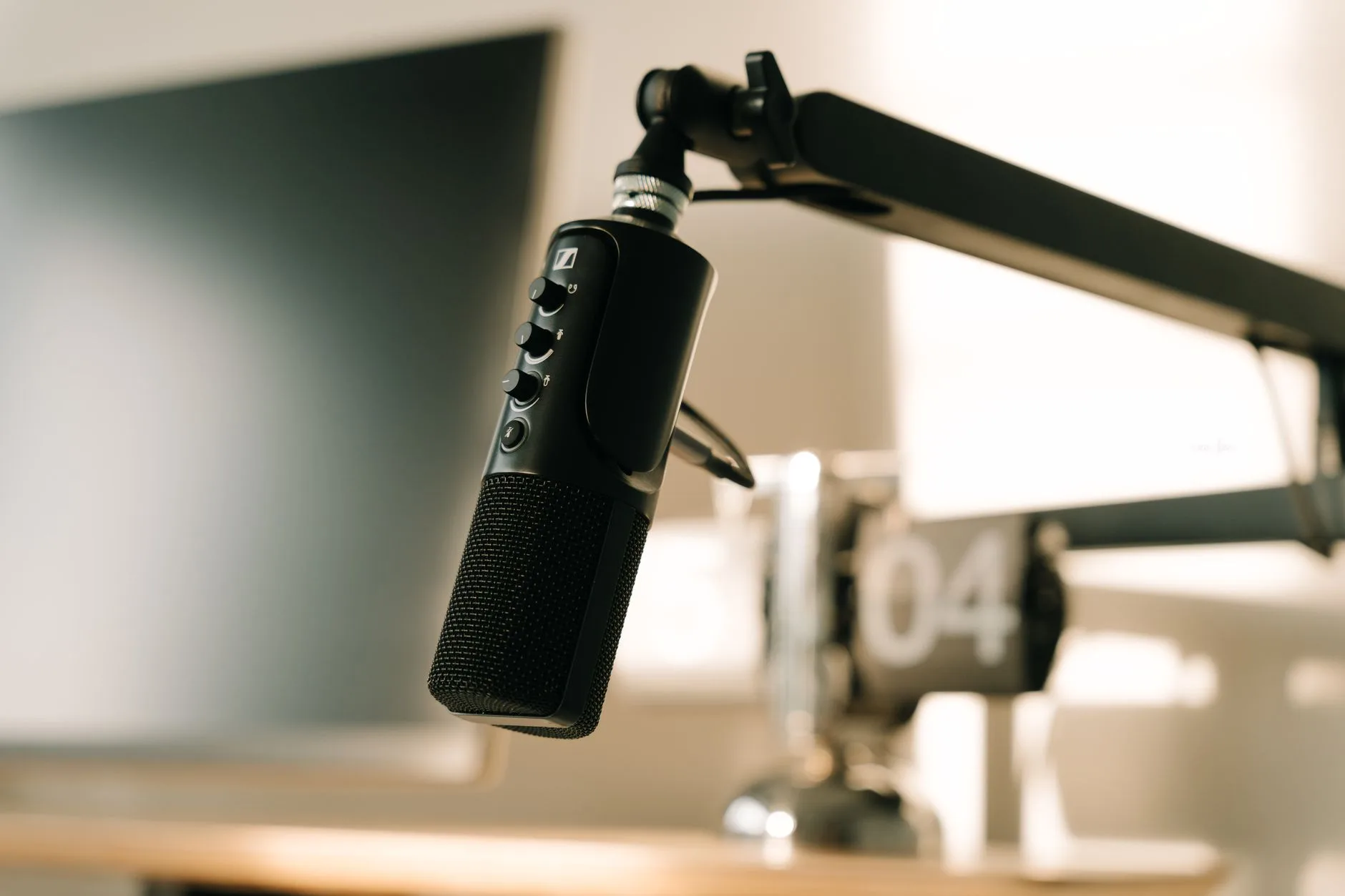 Streamer desk with microphone boom arm beside a monitor