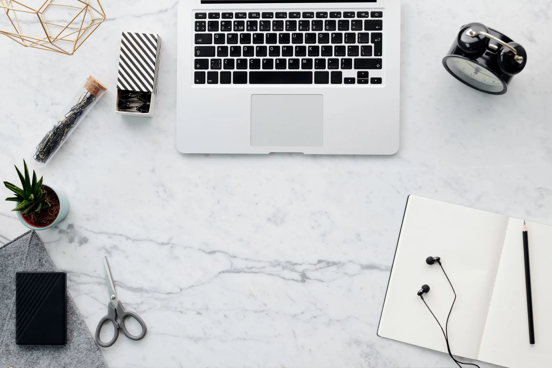 Tidy author writing desk with laptop and notebooks