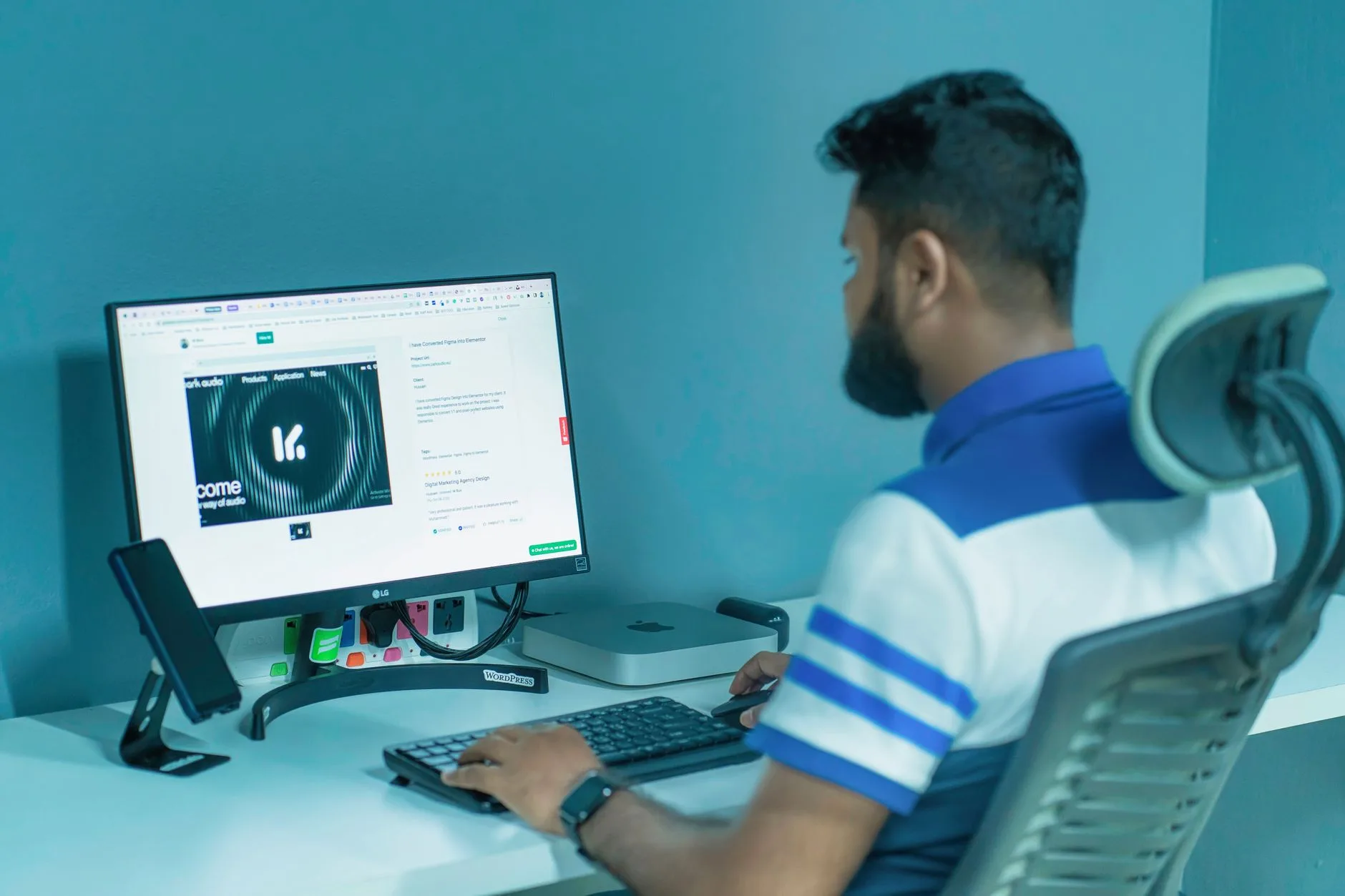 Office desk setup with monitor, keyboard and ergonomic chair