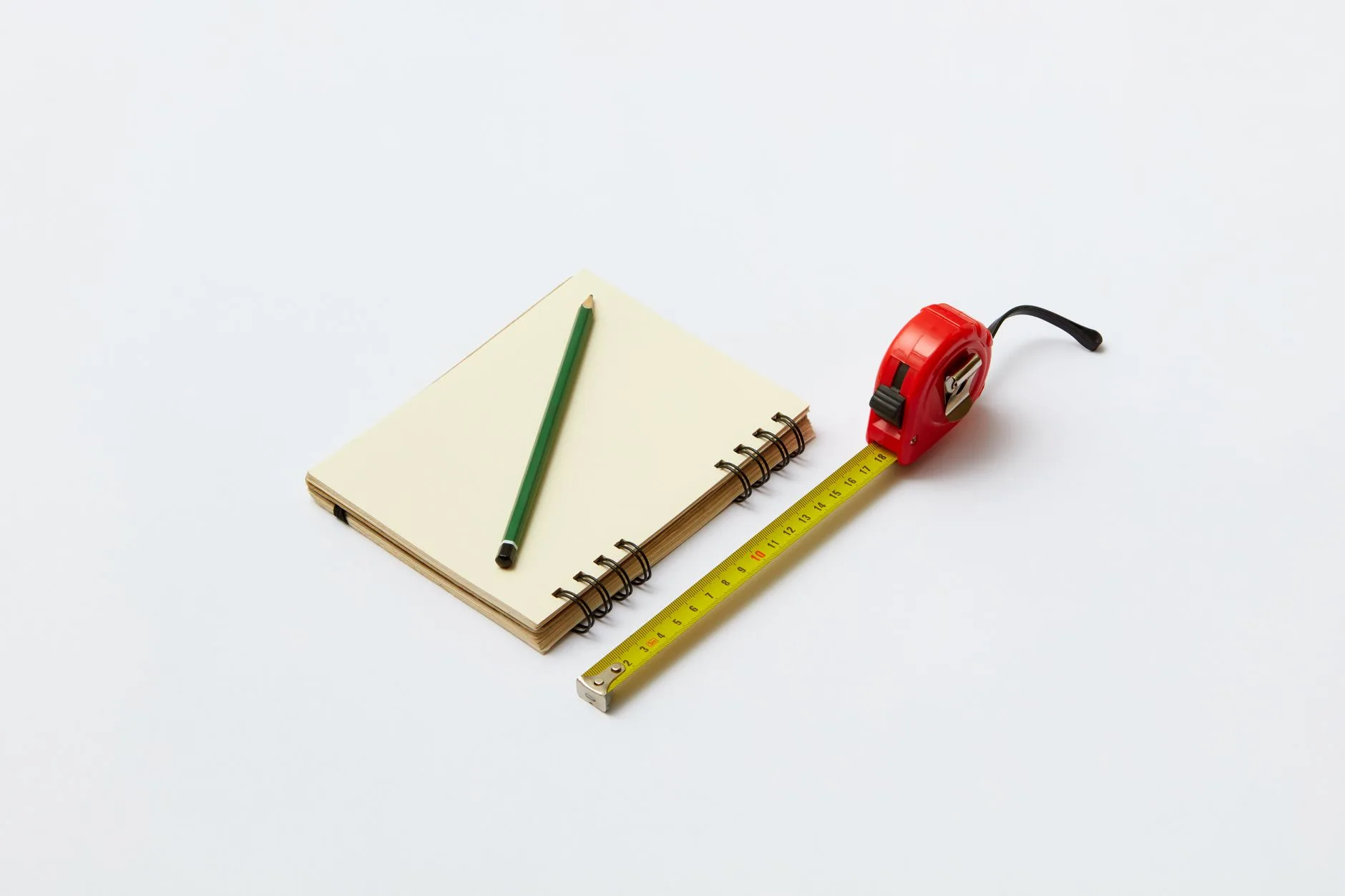 Tape measure checking desk width and depth before buying
