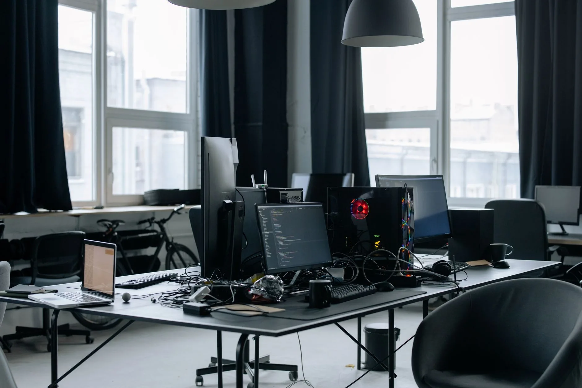 Messy multi monitor desk with visible cables